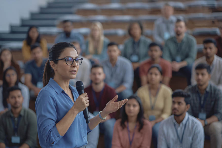 A speaker sharing an idea with a leadership audience